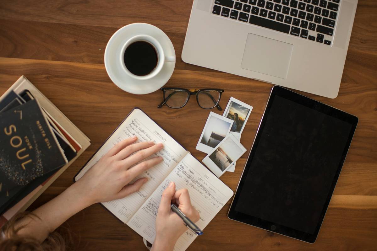 Professional studying certified financial planning course materials at desk with estate planning documents